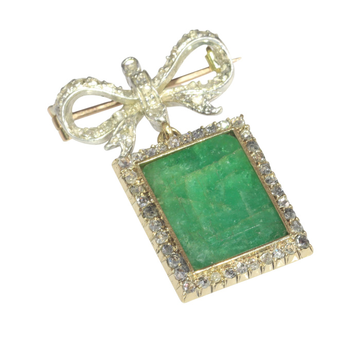 Antique Victorian diamond bow brooch with large emerald pendant hanging underneath by Artiste Inconnu