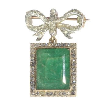 Antique Victorian diamond bow brooch with large emerald pendant hanging underneath by Artista Sconosciuto