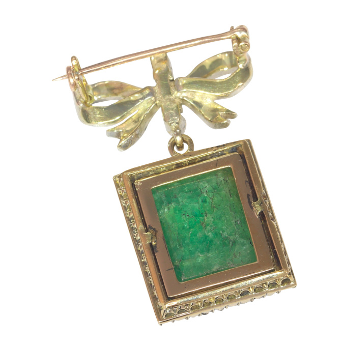 Antique Victorian diamond bow brooch with large emerald pendant hanging underneath by Artiste Inconnu