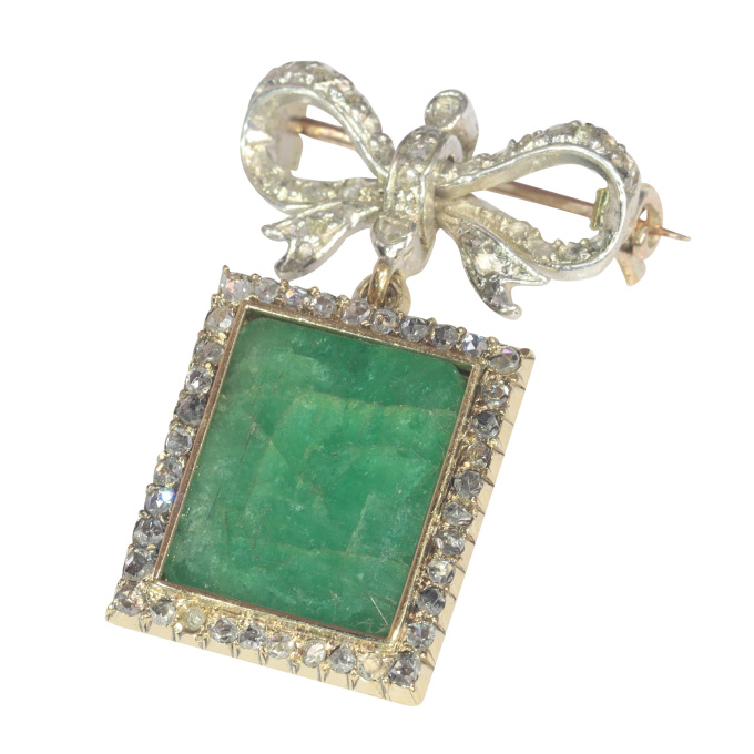 Antique Victorian diamond bow brooch with large emerald pendant hanging underneath by Artiste Inconnu