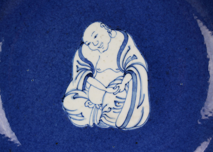 A Chinese powder-blue-ground blue and white ‘Budai’ dish, Kangxi period by Artiste Inconnu