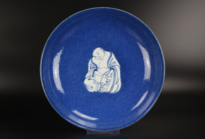 A Chinese powder-blue-ground blue and white ‘Budai’ dish, Kangxi period by Artiste Inconnu