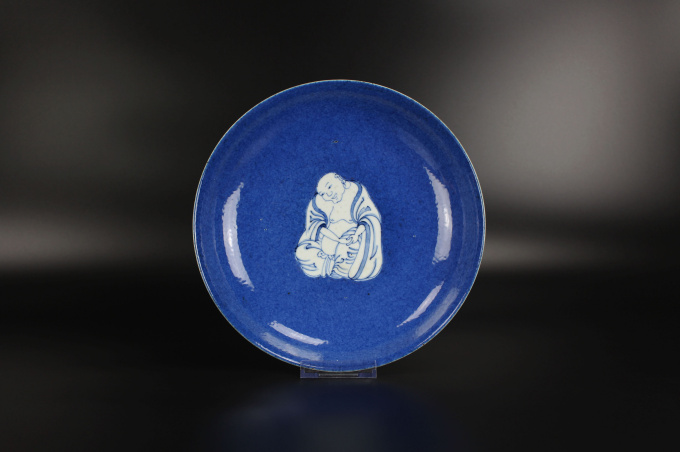 A Chinese powder-blue-ground blue and white ‘Budai’ dish, Kangxi period by Artiste Inconnu