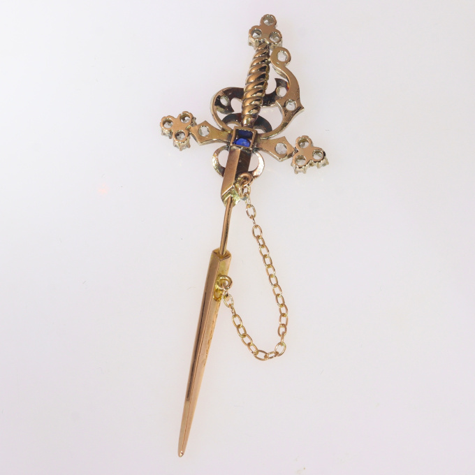 Vintage pin in the form of a sword set with diamonds and a sapphire by Artista Desconhecido