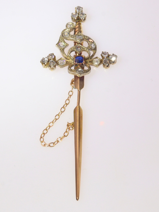 Vintage pin in the form of a sword set with diamonds and a sapphire by Artista Desconhecido